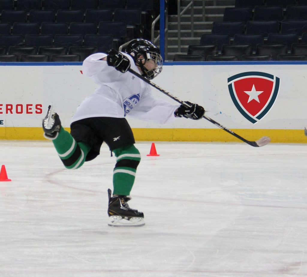 Child in UHL hockey clinic taking a Slapshot